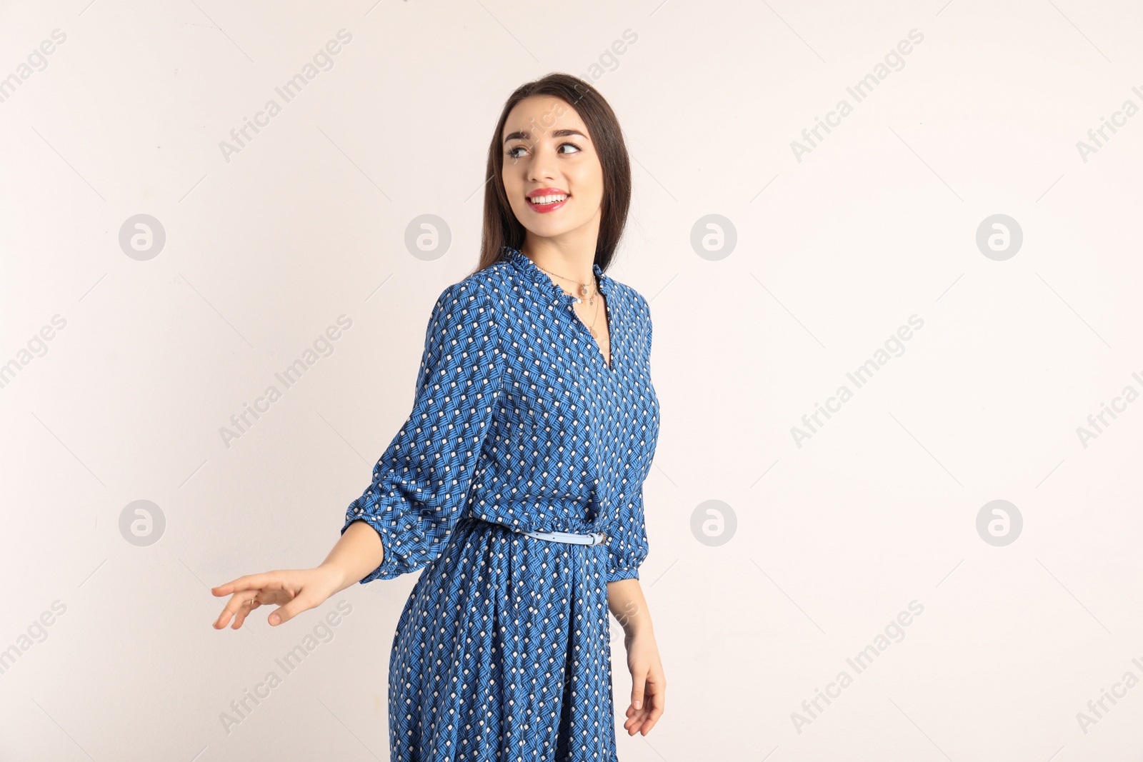 Photo of Portrait of beautiful young woman in stylish dress on white background