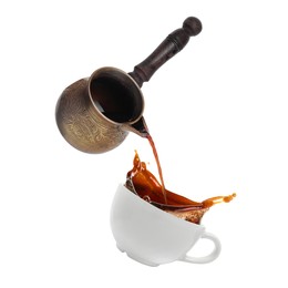 Pouring freshly brewed aromatic coffee from turkish pot into cup. Objects in air on white background