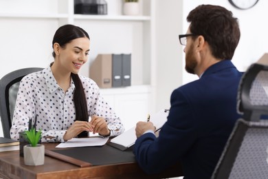 Young woman having meeting with lawyer in office