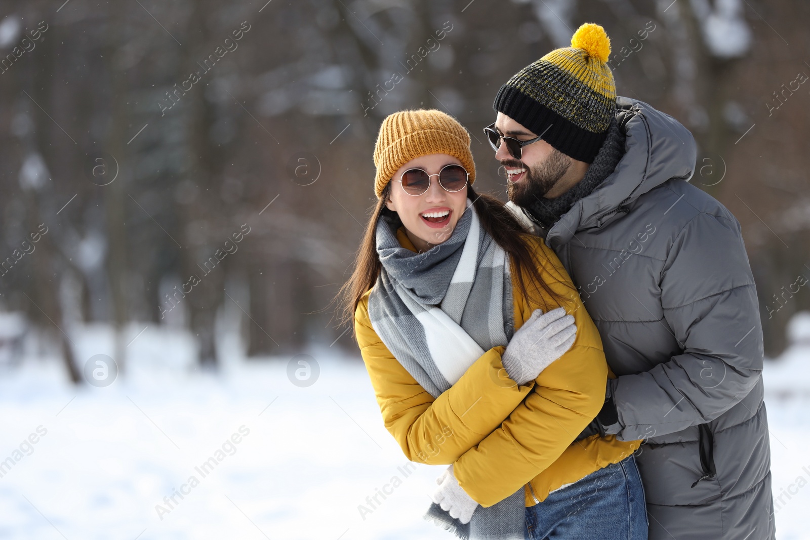 Photo of Beautiful happy couple outdoors on winter day. Space for text