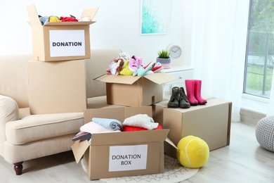 Carton boxes with donations in living room