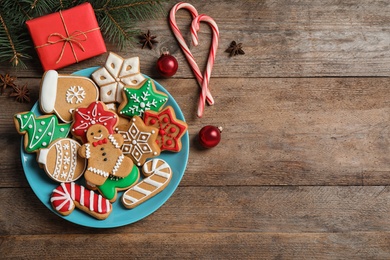 Photo of Flat lay composition with tasty homemade Christmas cookies on wooden table, space for text