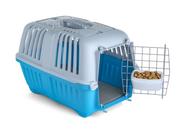 Photo of Light blue pet carrier with bowl of dry food isolated on white