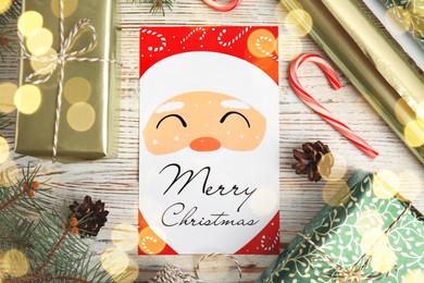 Photo of Flat lay composition with Christmas card and gift boxes on white wooden background