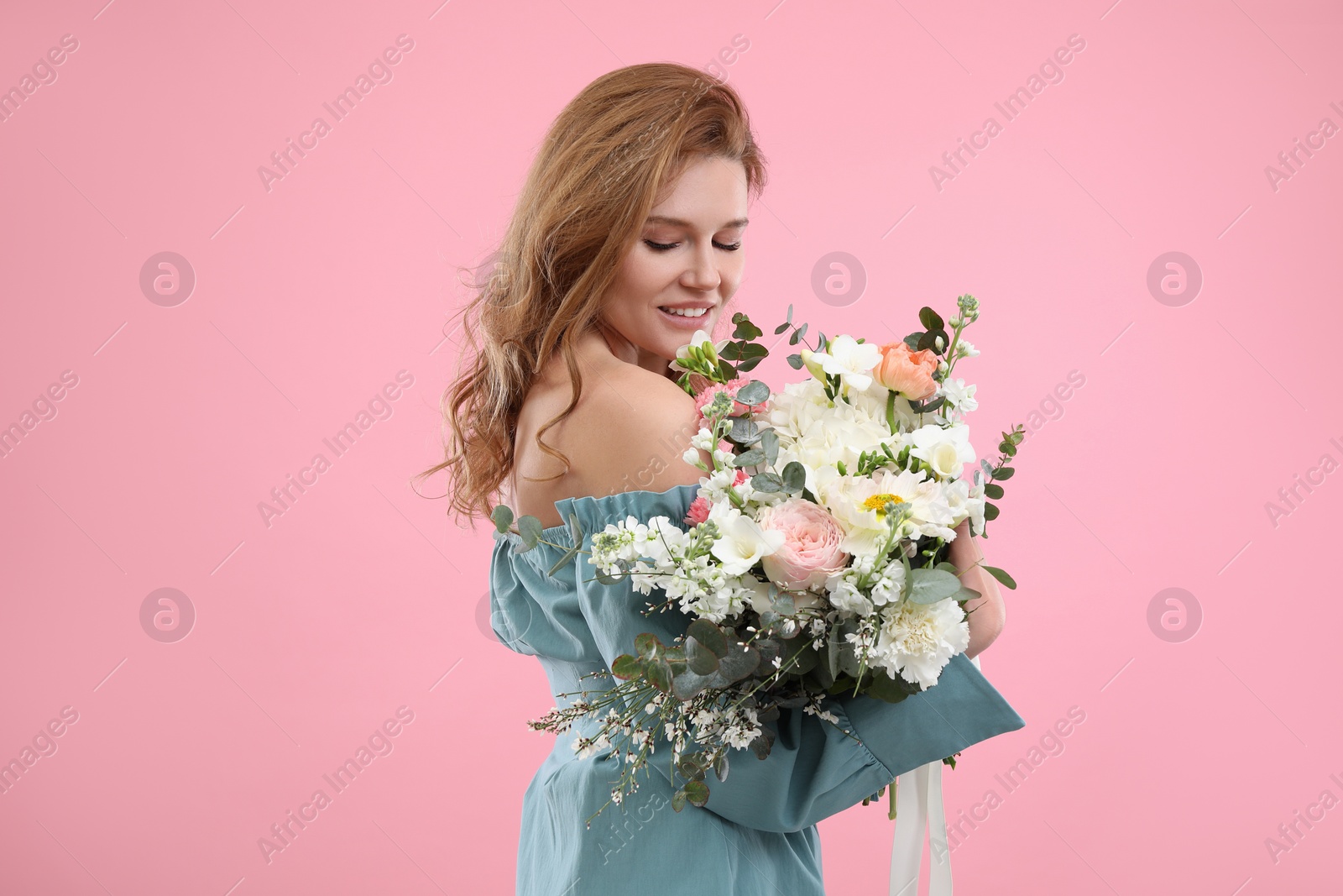Photo of Beautiful woman with bouquet of flowers on pink background