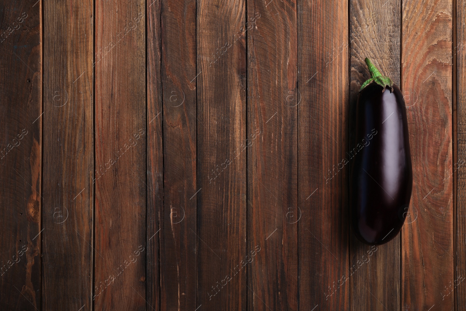 Photo of Raw ripe eggplant on wooden background, top view