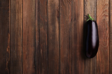 Photo of Raw ripe eggplant on wooden background, top view