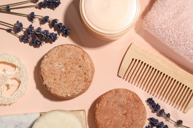 Photo of Flat lay composition of solid shampoo bars, lavender and comb on pink background. Hair care