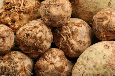 Photo of Fresh raw celery roots as background, closeup