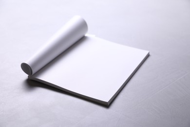 Blank paper sheets on grey textured table. Mockup for design