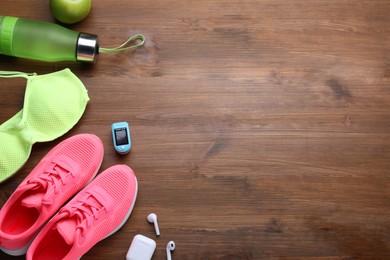 Photo of Flat lay composition with different cycling accessories on wooden background, space for text