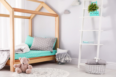 Photo of Stylish child room interior with comfortable bed