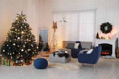 Cozy living room interior with beautiful Christmas tree and comfortable furniture