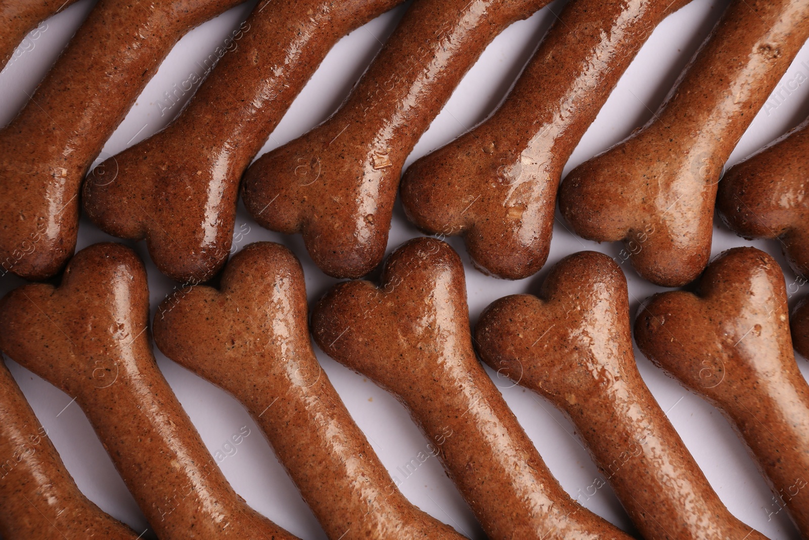 Photo of Flat lay composition with many bone shaped dog cookies on white background