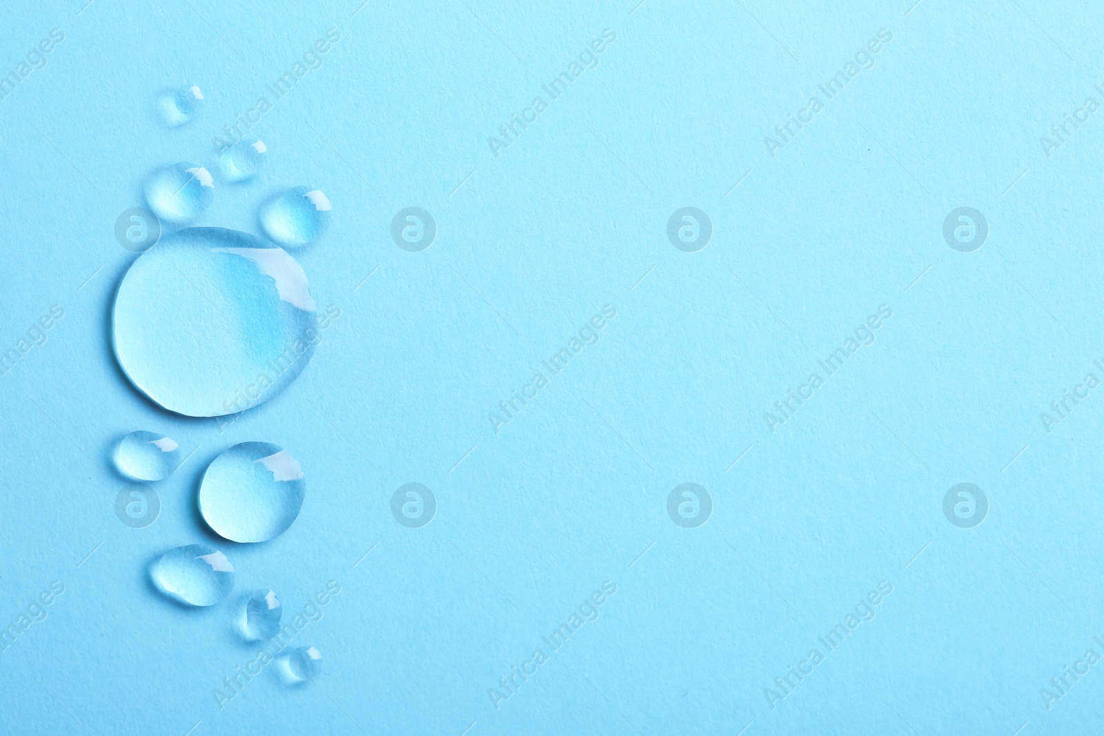 Photo of Water drops on color background, top view. Space for text