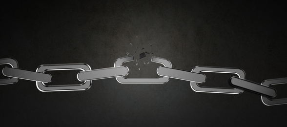 Broken metal chain on black background. Freedom concept 