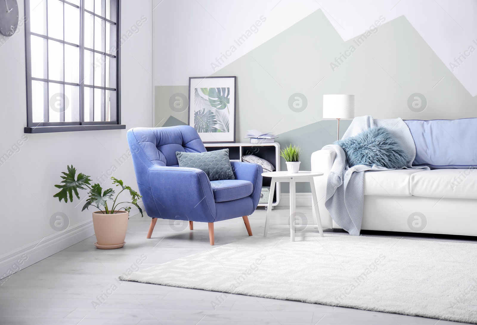 Photo of Stylish living room interior with comfortable sofa and armchair