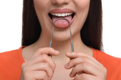 Woman brushing her tongue with cleaner on white background, closeup