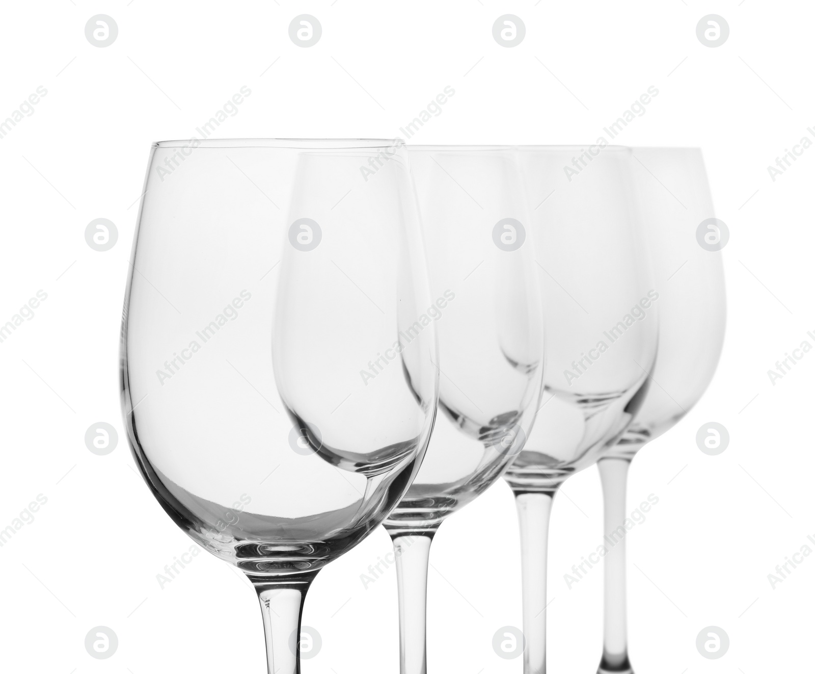 Photo of Empty clear wine glasses on white background