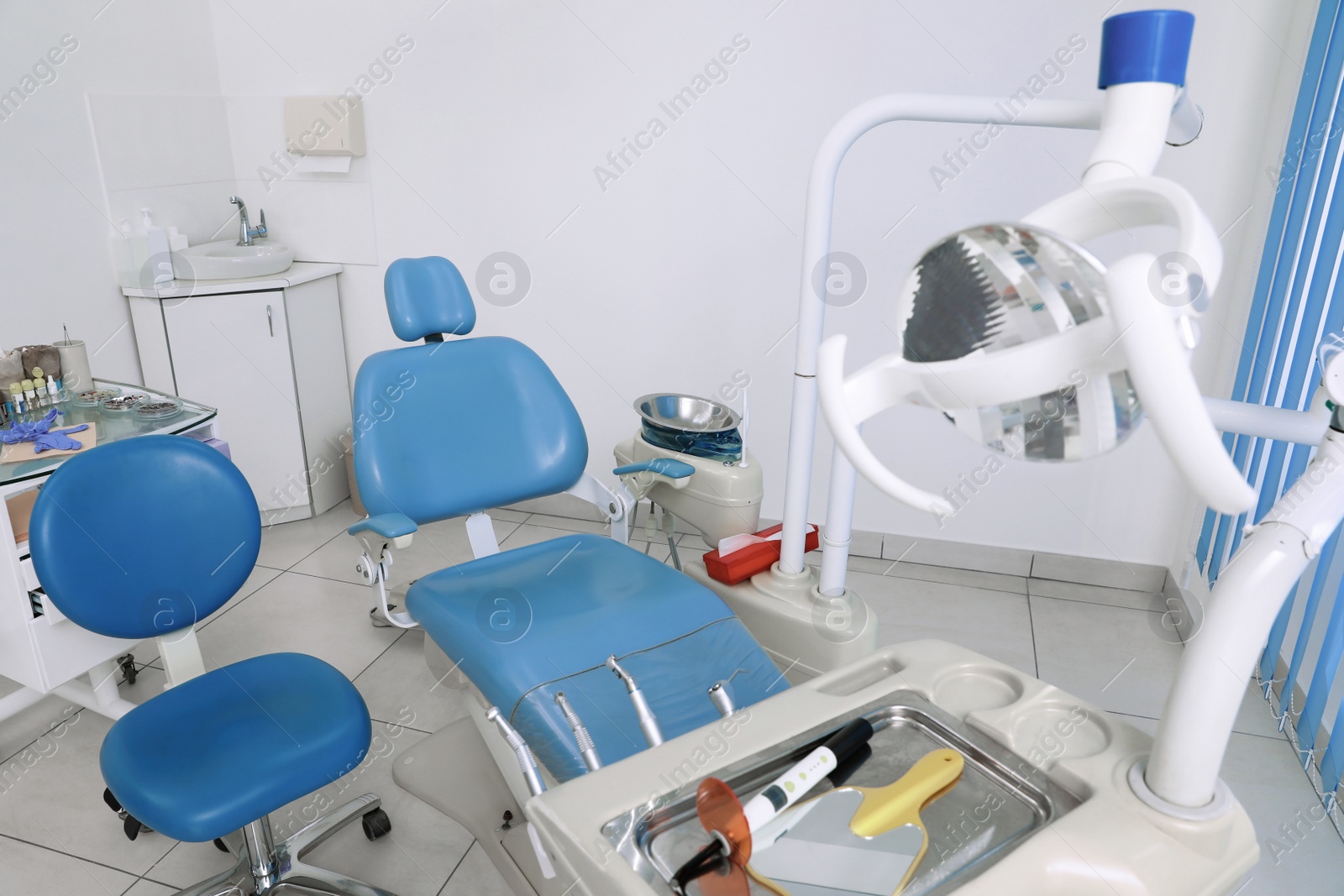 Photo of Dentist's office interior with chair and modern equipment