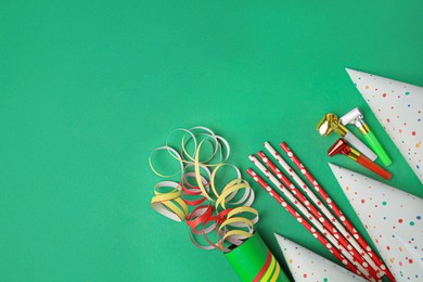 Photo of Many different party items on green background, flat lay. Space for text