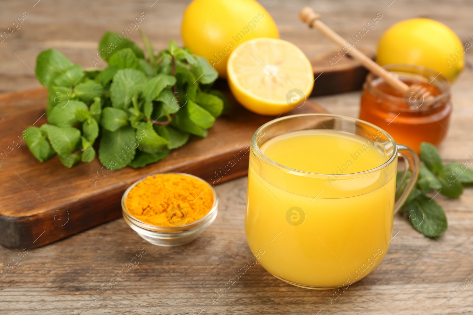 Photo of Immunity boosting drink and ingredients on wooden table