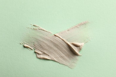 Photo of Sample of face mask on light green background, top view