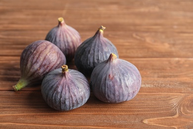 Ripe sweet figs on wooden background. Tropical fruit