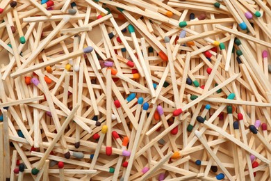 Photo of Matches with colorful heads as background, top view