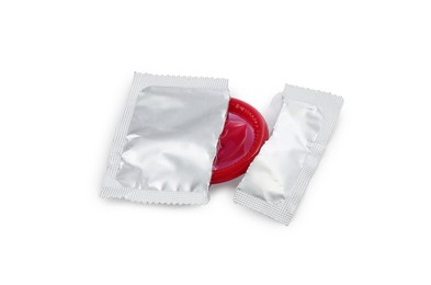 Condom in torn package on white background. Safe sex