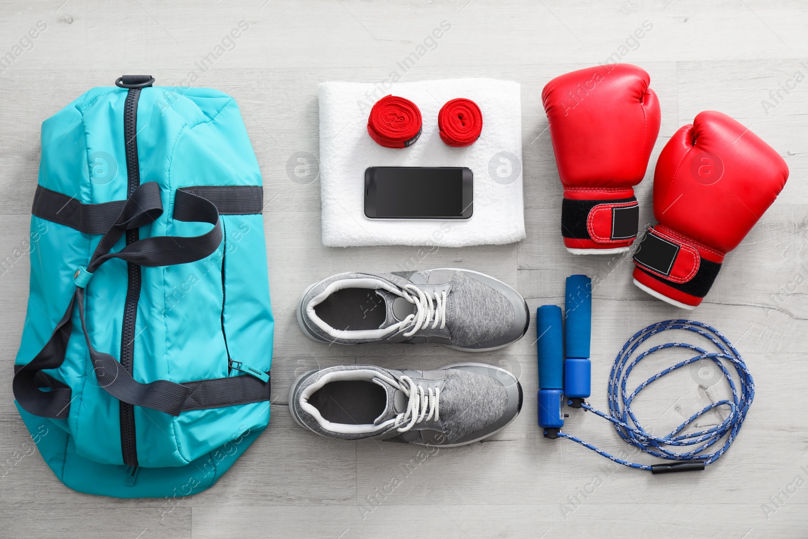 Photo of Flat lay composition with sports bag on wooden floor