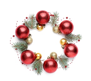 Beautiful Christmas wreath made of shiny red baubles, garland and fir branches on white background, top view