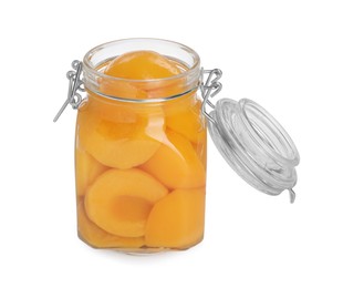 Glass jar with canned peach halves isolated on white