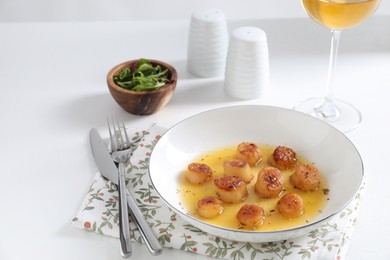 Photo of Delicious fried scallops served on white table