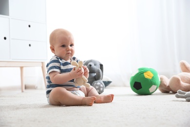 Photo of Cute little baby on carpet indoors. Crawling time