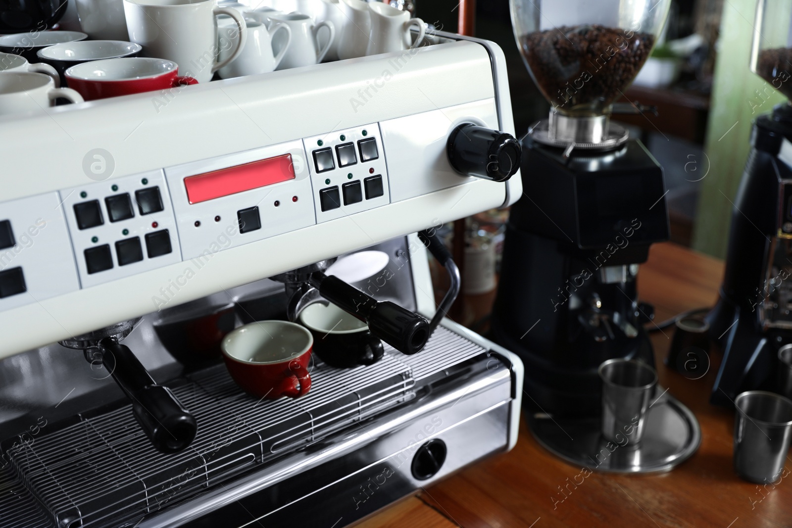 Photo of Modern coffee machine on bar counter in cafe. Space for text