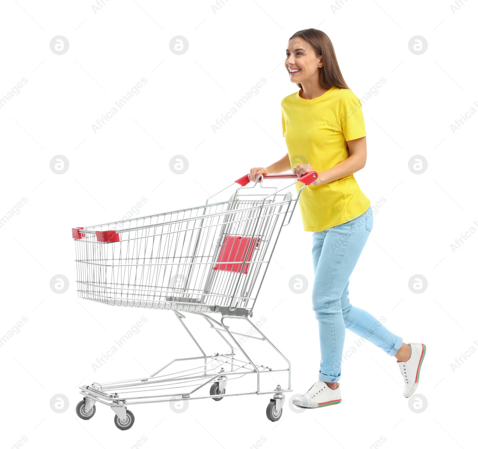 Photo of Young woman with empty shopping cart on white background