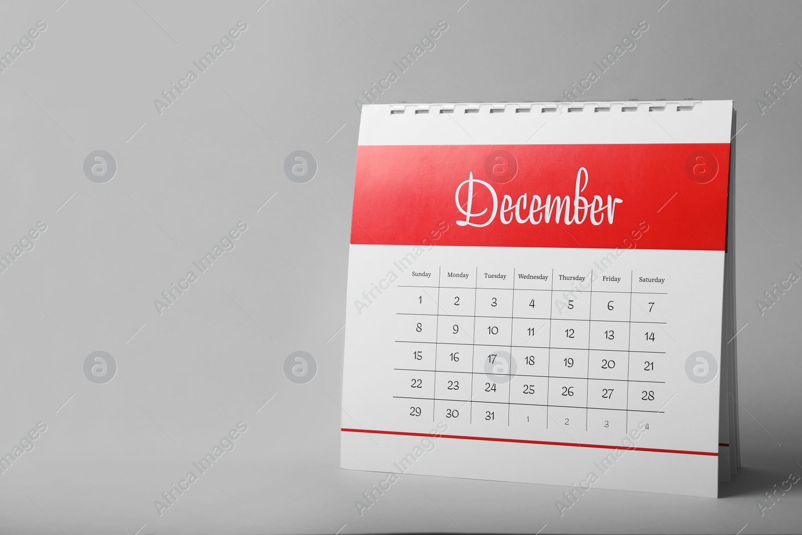 Photo of Paper calendar on grey background, space for text. Planning concept