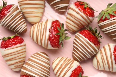 Photo of Delicious chocolate covered strawberries on pink plate, top view