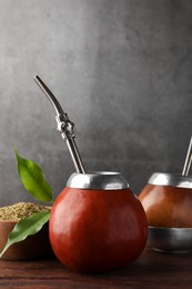 Photo of Calabash with mate tea and bombilla on wooden table