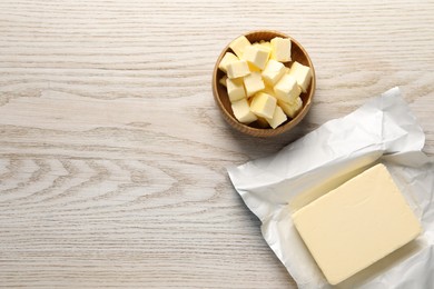 Photo of Tasty butter on light wooden table, flat lay. Space for text