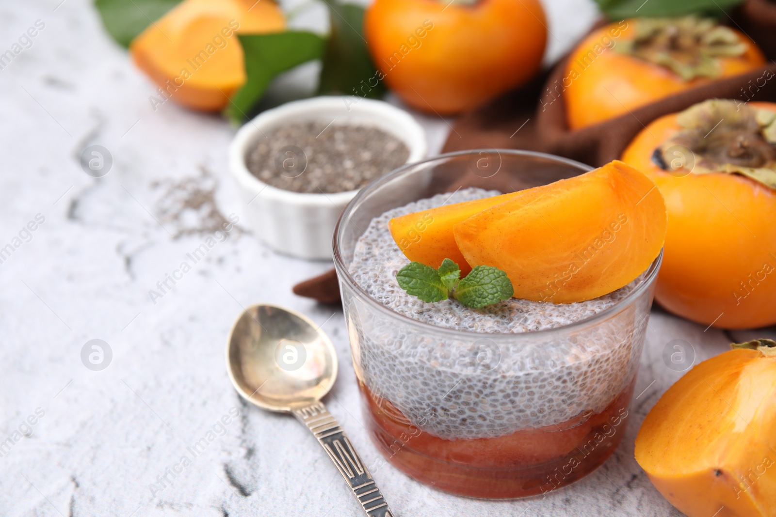 Photo of Delicious dessert with persimmon and chia seeds on table