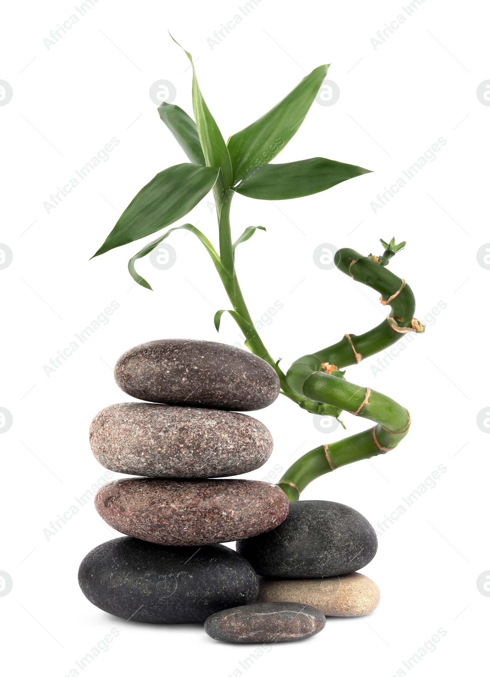 Photo of Stacks of spa stones and bamboo on white background