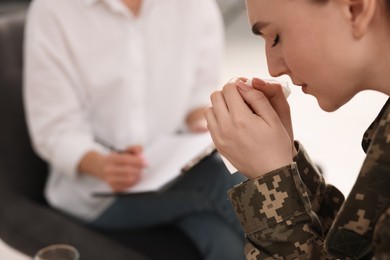 Photo of Psychotherapist working with military woman in office, closeup