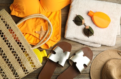 Flat lay composition with beach objects on wooden background