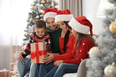 Happy family with Christmas gift at home