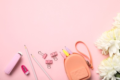 Flat lay composition with flowers and stationery on pink background, space for text. Teacher's day