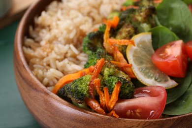 Photo of Tasty fried rice with vegetables in bowl, closeup