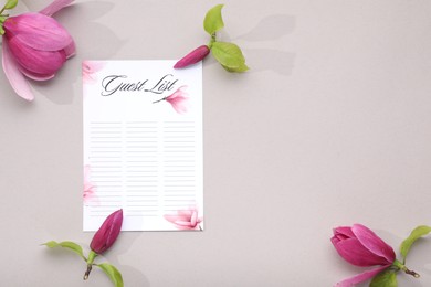 Photo of Guest list and beautiful flowers on grey background, flat lay. Space for text