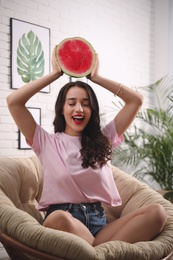 Photo of Beautiful young woman with watermelon at home